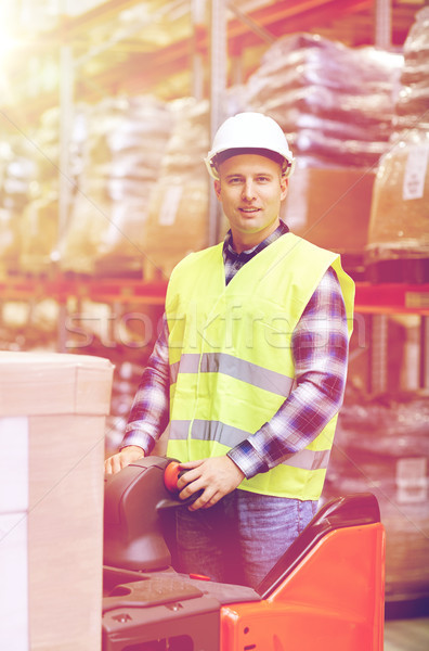 man on forklift loading boxes at warehouse Stock photo © dolgachov