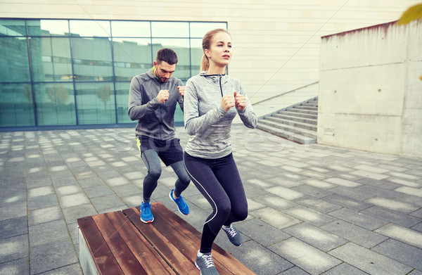 couple making step exercise on city street bench Stock photo © dolgachov