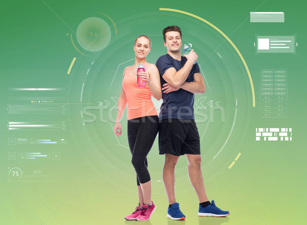 sportive man and woman with water bottles Stock photo © dolgachov