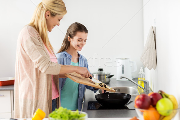 happy family cooking food at home kitchen Stock photo © dolgachov
