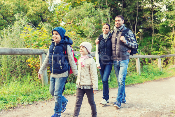 happy family with backpacks hiking in woods Stock photo © dolgachov