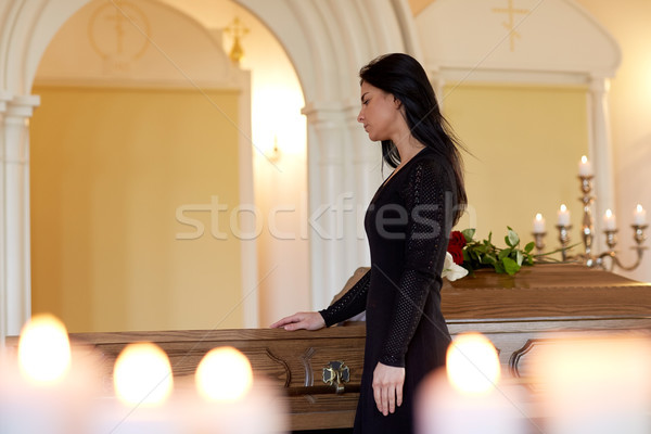 sad woman with coffin at funeral in church Stock photo © dolgachov