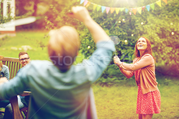 Szczęśliwy znajomych gry badminton lata ogród Zdjęcia stock © dolgachov