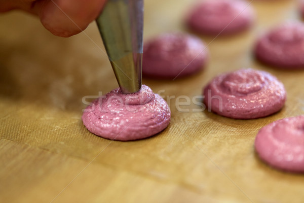 chef with nozzle squeezing macaron batter Stock photo © dolgachov