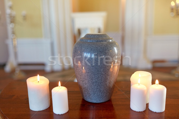 cremation urn and candles burning in church Stock photo © dolgachov