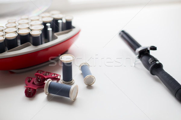 hot rollers kit on table with hair clips and iron Stock photo © dolgachov