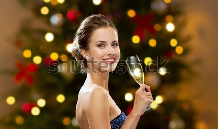 beautiful woman in red dress over christmas tree Stock photo © dolgachov