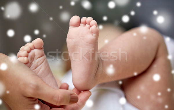 close up of newborn baby feet in mother hands Stock photo © dolgachov