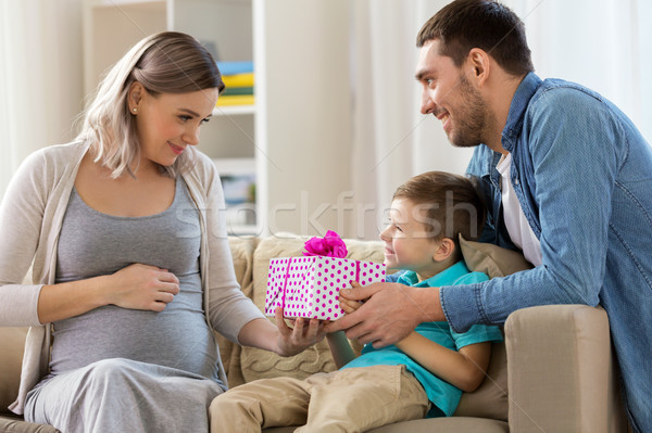 family giving present to pregnant mother at home Stock photo © dolgachov