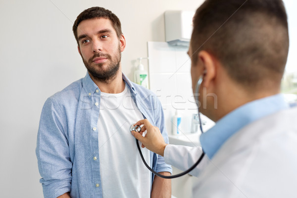 doctor with stethoscope and patient at hospital Stock photo © dolgachov