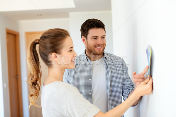 happy couple with color samples at new home Stock photo © dolgachov