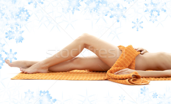 Longues jambes dame orange serviette flocons de neige [[stock_photo]] © dolgachov