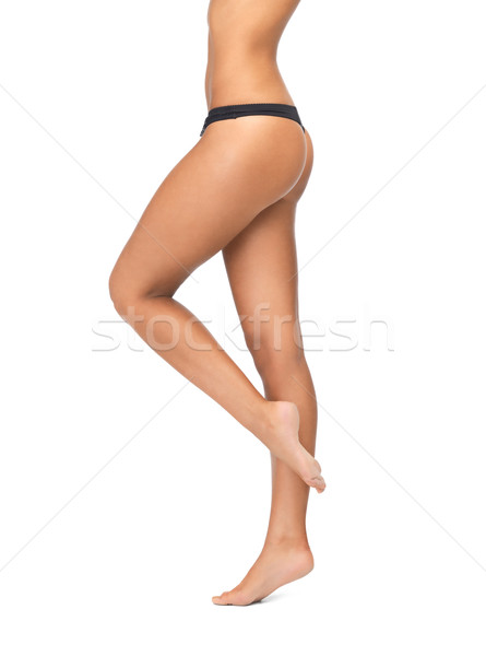 Stock photo: female legs in black bikini panties