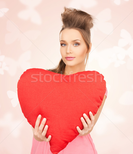 happy and smiling woman with heart-shaped pillow Stock photo © dolgachov