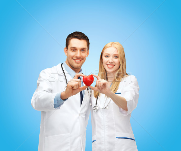smiling doctors cardiologists with heart Stock photo © dolgachov