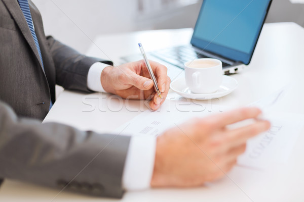 man hands with contract and pen, coffee and laptop Stock photo © dolgachov