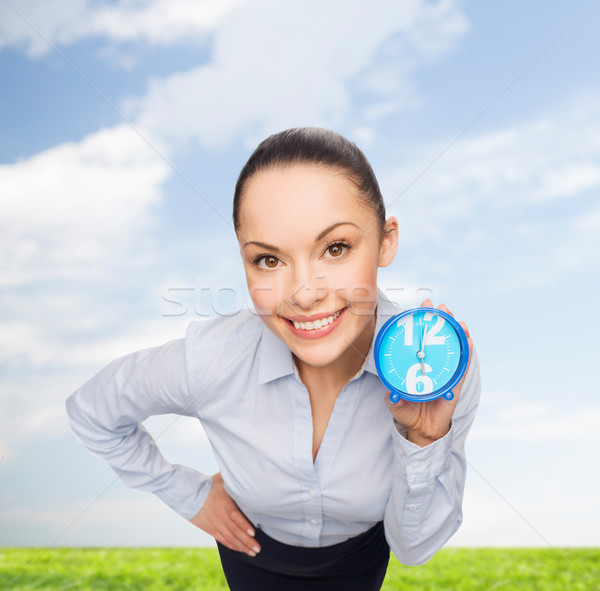 smiling businesswoman with blue clock Stock photo © dolgachov