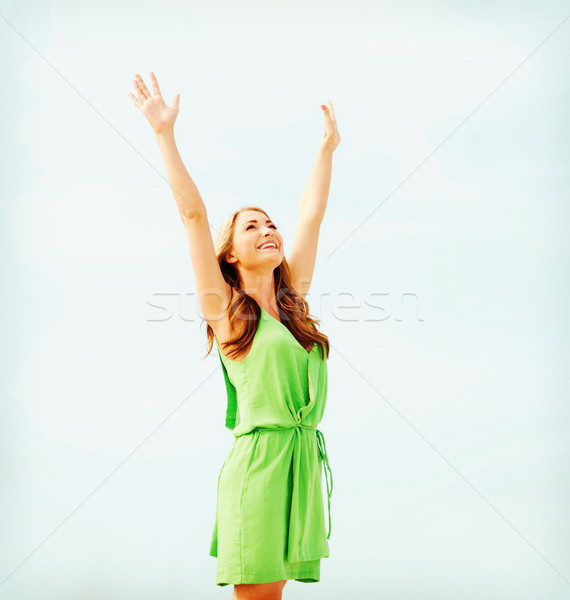 girl with hands up in harbour Stock photo © dolgachov