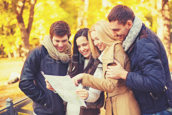 couples with tourist map in autumn park Stock photo © dolgachov