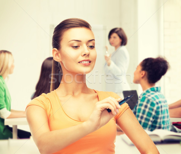 student writing something in the air with marker Stock photo © dolgachov