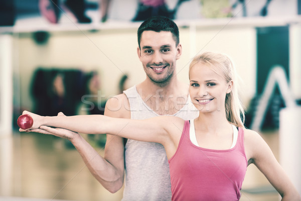 male trainer with woman working out with dumbbell Stock photo © dolgachov