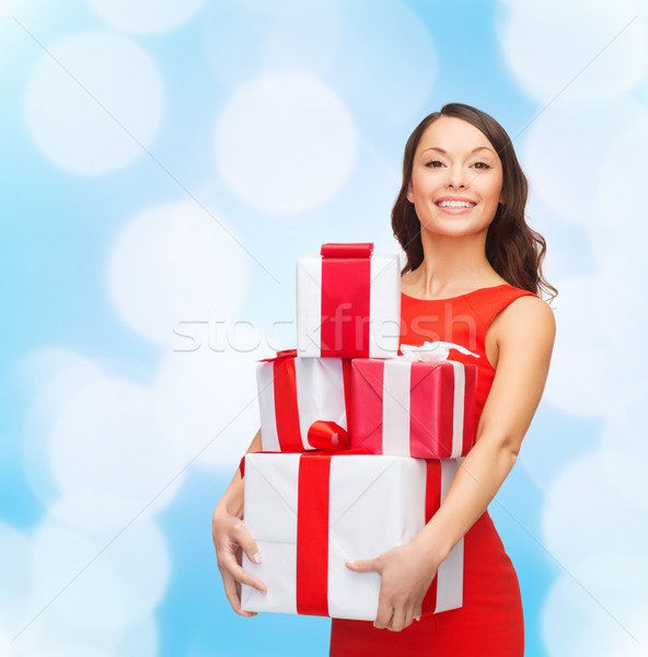 smiling woman in red dress with gift boxes Stock photo © dolgachov
