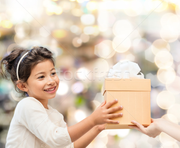 smiling little girl with gift box stock photo © dolgachov