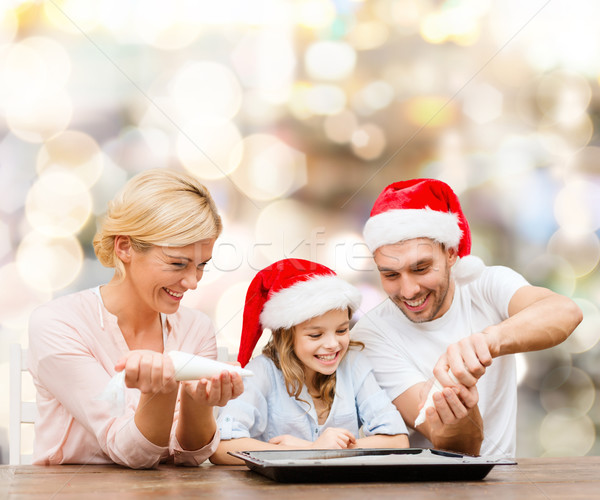 happy family in santa helper hats cooking Stock photo © dolgachov
