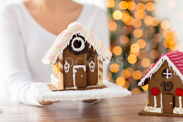 close up of woman showing gingerbread house Stock photo © dolgachov