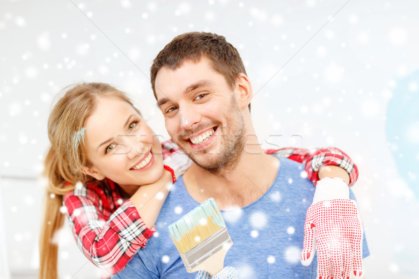 smiling couple with paintbrush at home Stock photo © dolgachov