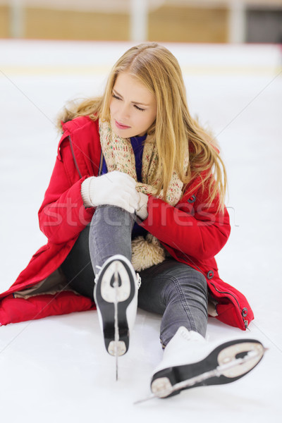 young woman fell down on skating rink Stock photo © dolgachov