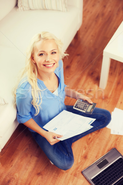 smiling woman with papers, laptop and calculator Stock photo © dolgachov