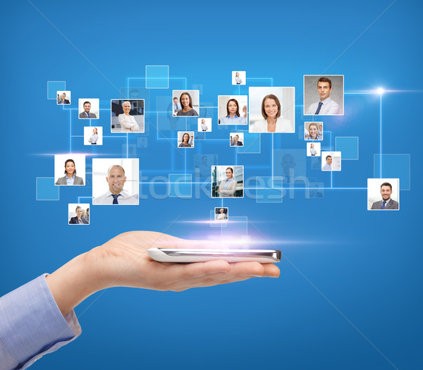 woman hand with smartphone over icons of contacts Stock photo © dolgachov