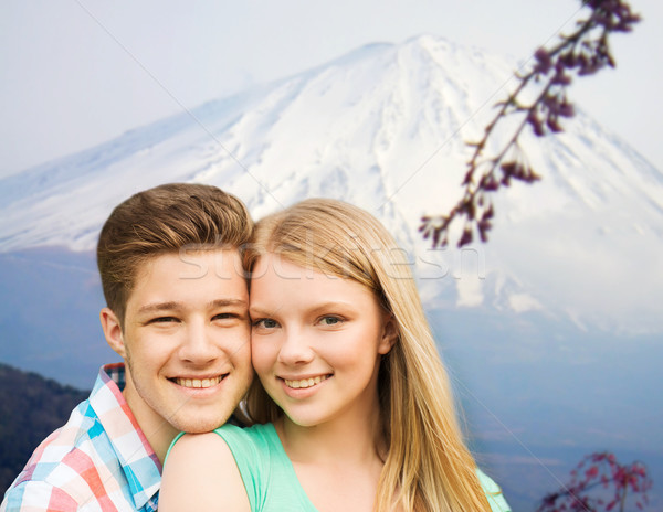 smiling couple hugging over mountains background Stock photo © dolgachov