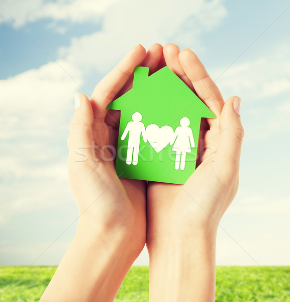 hands holding green house with family Stock photo © dolgachov