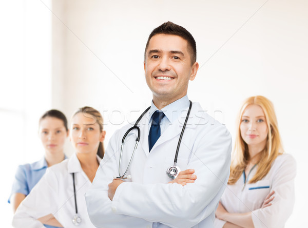 smiling male doctor in white coat at hospital Stock photo © dolgachov