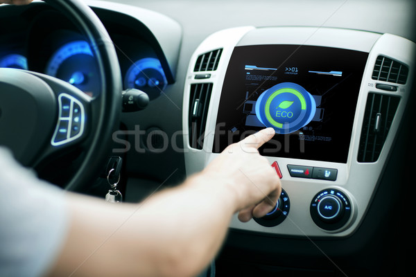 Stock photo: male hand setting car eco system mode on screen