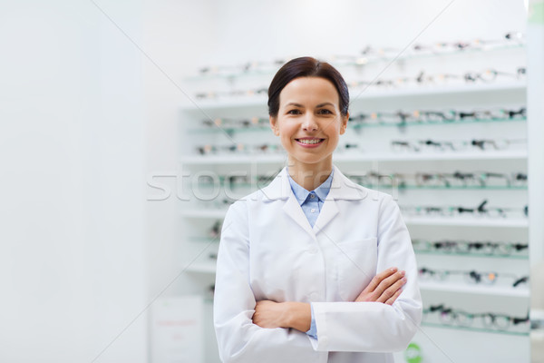 woman optician over glasses at optics store Stock photo © dolgachov