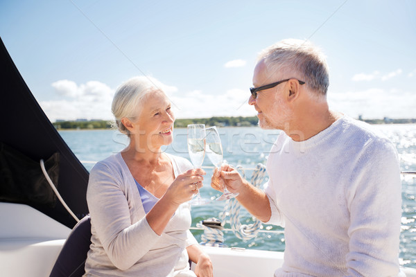 senior couple clinking glasses on boat or yacht Stock photo © dolgachov