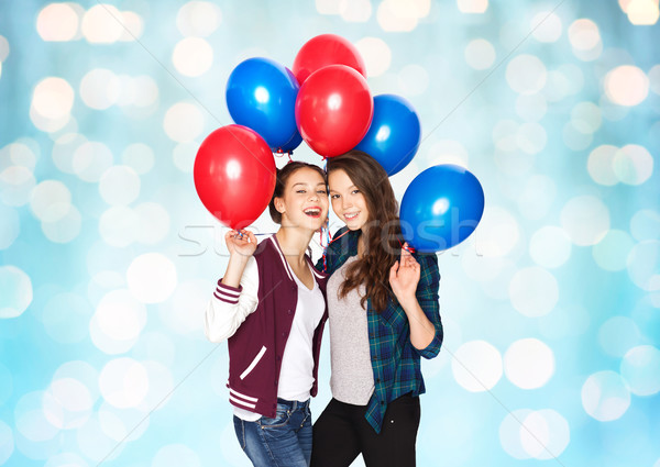 happy teenage girls with helium balloons Stock photo © dolgachov