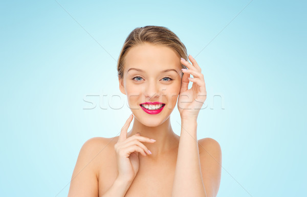 smiling young woman with pink lipstick on lips Stock photo © dolgachov