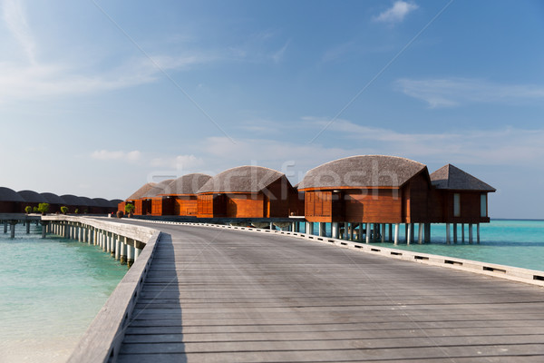 bungalow huts in sea water on exotic resort beach Stock photo © dolgachov