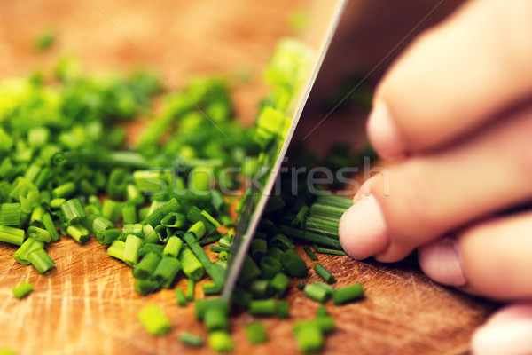 close up of woman chopping green onion with knife Stock photo © dolgachov