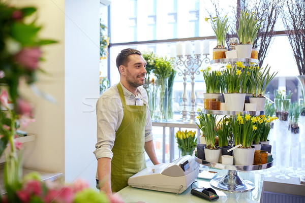 Stock photo: florist man or seller at flower shop counter