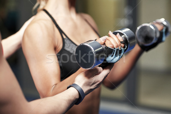 woman with dumbbells flexing muscles in gym Stock photo © dolgachov