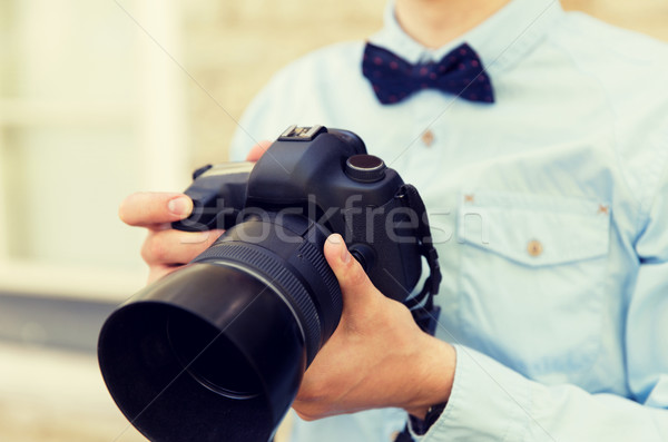 close up of male photographer with digital camera Stock photo © dolgachov