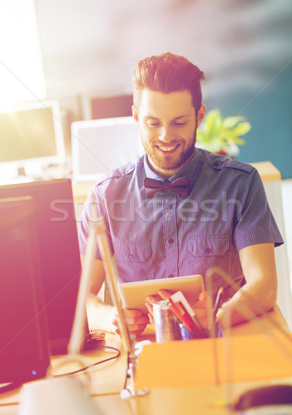 happy creative male office worker with tablet pc Stock photo © dolgachov