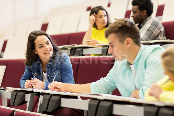 group of students with notebooks in lecture hall Stock photo © dolgachov