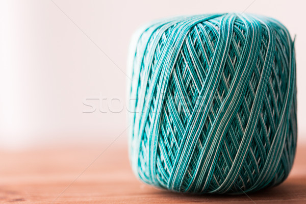 ball of turquoise cotton yarn on wood Stock photo © dolgachov