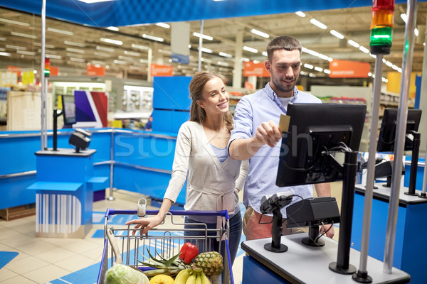 couple buying food at grocery store cash register Stock photo © dolgachov